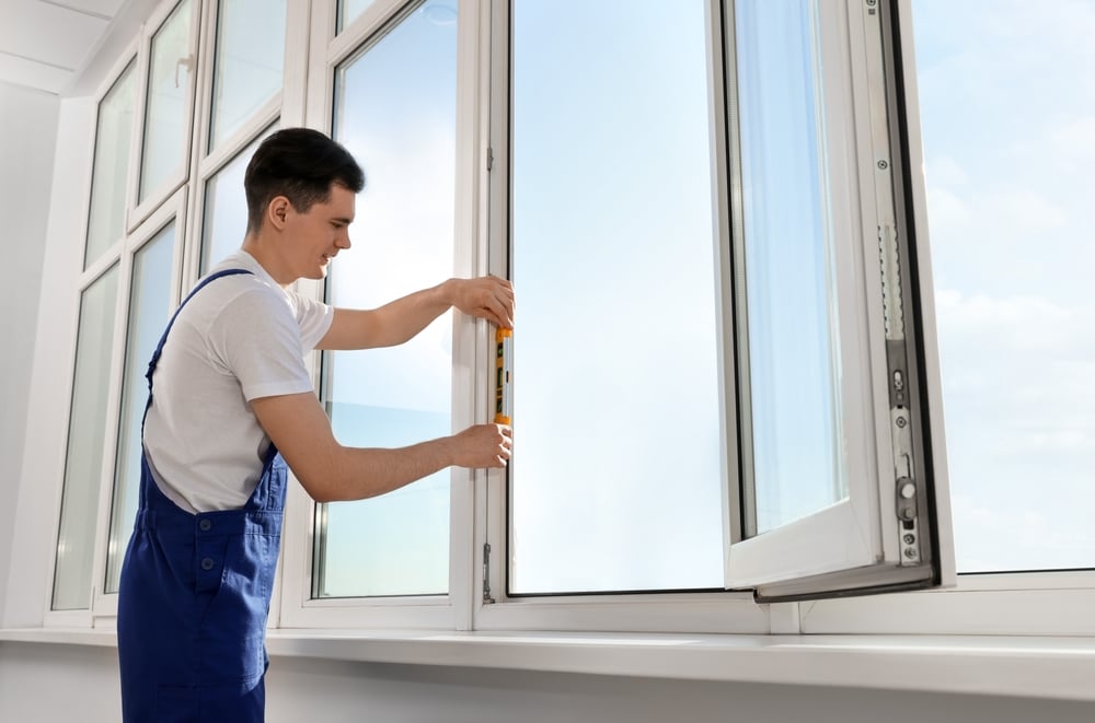 Windows replacement company’s worker replacing windows