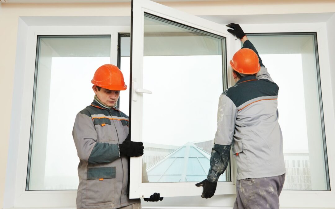 Two men installing a window